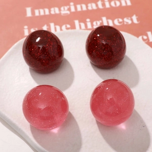 Macro detail of glitter resin cherry beads for DIY jewelry and accessory making