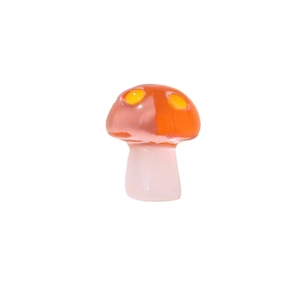 Translucent resin mushroom charm with orange spotted cap and light pink stem