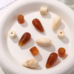 Vintage teardrop and cylinder resin beads in amber and marble white for DIY earring making