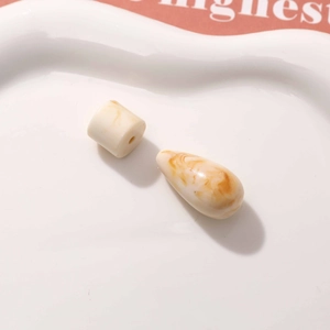Close-up of marble-textured resin beads in beige and brown for DIY earring making