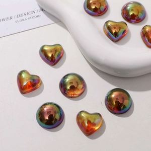 Macro detail of colorful metallic resin heart and round charms for DIY jewelry accessories