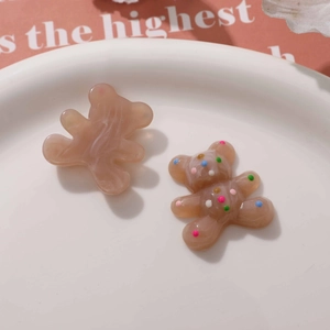 Close-up of cute resin bear charms with marble texture and colorful polka dots