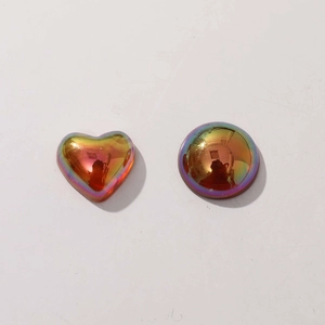 Close-up of geometric iridescent resin heart and semicircle DIY jewelry charm parts