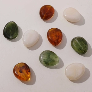 Polished resin teardrop beads in amber, milk white and dark green for DIY jewelry making