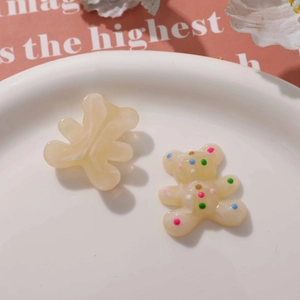 Close-up of cute marble and polka dot resin bear charms for DIY jewelry and accessories