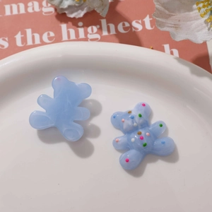 Macro detail of cute blue resin bear charms for DIY jewelry and phone case decoration