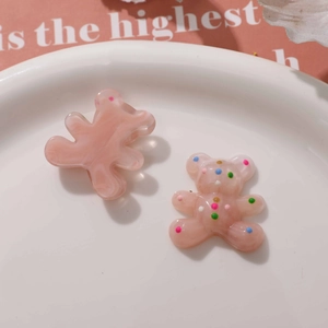 Detailed view of cute resin bear charms with pink marble texture and colorful dots