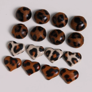 Detail of DIY heart and round leopard print buttons for jewelry and crafts making