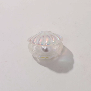 Macro view of iridescent shell accessory with white pearl center for DIY crafts