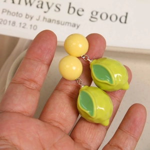 Creative 3D lemon resin drop earrings with yellow sphere and green leaf detail