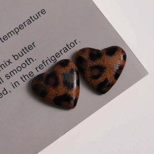 Detailed view of heart-shaped leopard print faux leather patches for DIY crafts