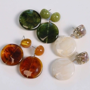 Three pairs of vintage resin dangle earrings with marble texture in various colors
