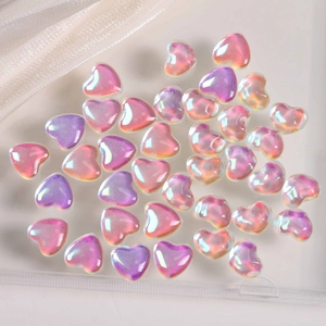 Macro detail of iridescent heart-shaped resin beads for DIY jewelry and nail art crafts