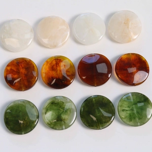 Macro detail of geometric resin beads featuring smoky marble texture in three colors