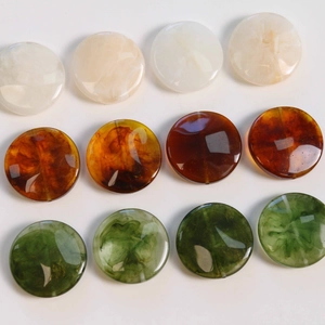 Macro shot of flat round resin beads with vintage marble smoke pattern in various colors