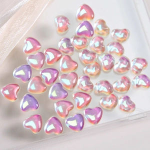 Macro detail of iridescent heart-shaped resin beads for DIY jewelry and nail art