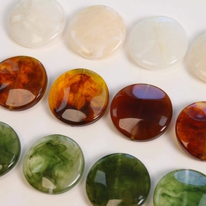 Macro view of polished resin beads with vintage smoke texture for DIY jewelry making