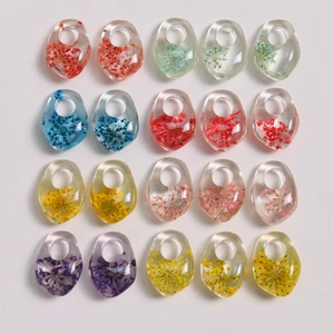 Detailed grid of irregular resin pendants with colorful dried flowers for DIY jewelry making