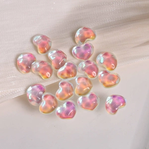 Close-up of iridescent heart-shaped resin beads for DIY jewelry and phone case decor