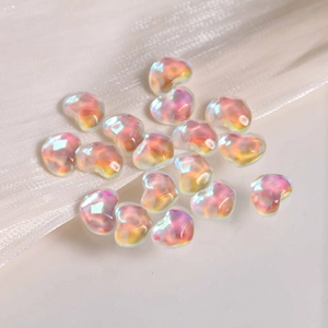 Macro shot of iridescent heart-shaped glass beads for DIY crafts and nail art decor