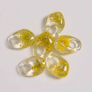 Detailed set of 6 irregular transparent resin pendants with yellow dried flowers inside