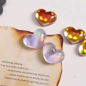 Macro shot of translucent aurora heart resin charms with iridescent finish for DIY crafts