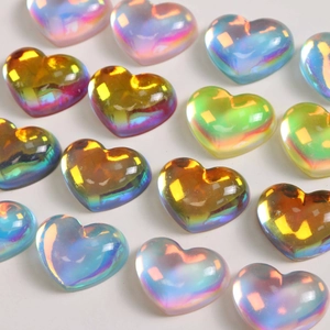 Macro detail of large translucent resin heart charms with iridescent AB coating for DIY crafts