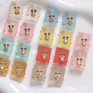Macro detail of colorful square resin bunny charms with gold-plated rabbit head accents