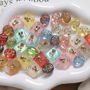 Close-up of matte resin rabbit and planet charms for DIY jewelry and nail art