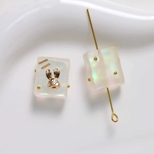 Detail showing gradient frosted resin rabbit square beads with gold inlay for DIY jewelry