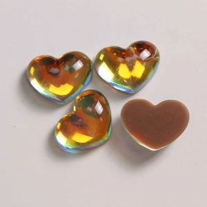 Detail of four gradient heart-shaped resin charms with aurora AB coating and flat back