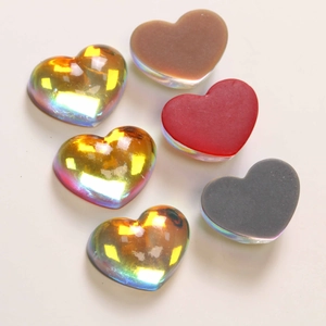 Macro shot of colorful gradient resin heart charms in metallic and solid finishes