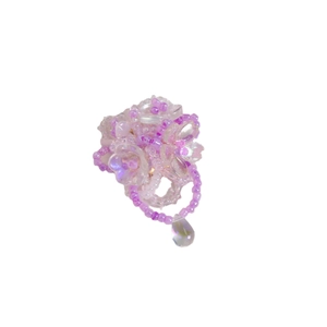 Handmade beaded flower ring with purple crystal beads and water drop pendant on white background