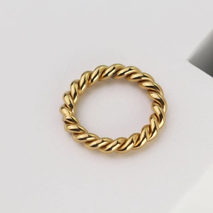 Detailed close-up of a 18k gold plated twisted rope ring with a polished metallic finish