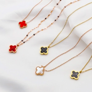 Detail of four-leaf clover necklaces in gold and rose gold with various stone inlays