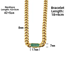 Detail shot of gold Cuban chain necklace and bracelet set with green rectangular pendants