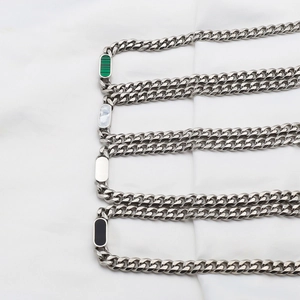 Detail of Cuban link chains with mother of pearl and malachite inlay rectangle charms