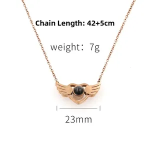 Rose gold heart pendant with wings showing precise 23mm width and 47cm chain length