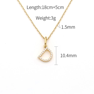 Macro view of gold D-letter pendant necklace with measurements and crystal details