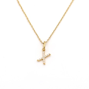 Detailed macro of golden letter X pendant necklace set with sparkling white crystals