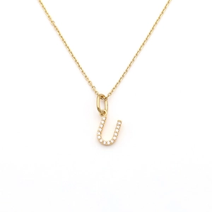 Detailed close-up of a sparkling micro-pave letter U pendant on a fine gold chain necklace