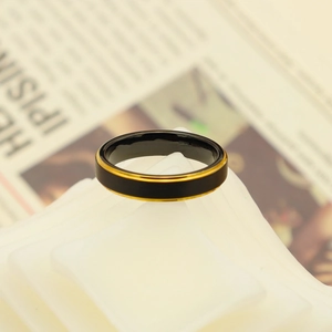 Detail of minimalist black tungsten steel ring with elegant dual gold borders for men