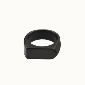 Macro shot of a black matte rectangular signet ring made of durable titanium steel
