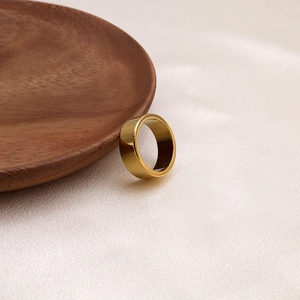 Minimalist 18K gold-plated irregular stainless steel ring on elegant silk fabric