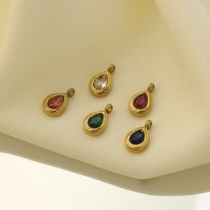 Five colored teardrop birthstone pendants with 18k gold plating on white silk background