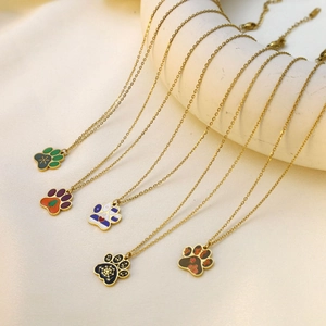 Detailed view of festive paw-shaped necklaces with colorful enamel and gold finish chains