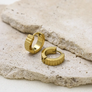 Textured gold hoop earrings with vertical ridges and a matte frosted finish on stone