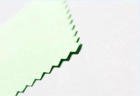 Light green microfiber jewelry cleaning cloth with distinctive serrated edges on white background