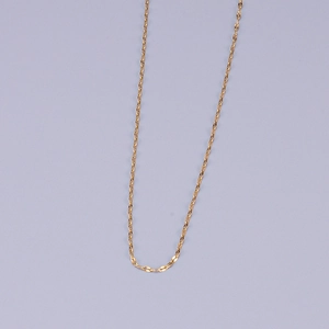 Minimalist gold plated stainless steel twisted rope chain necklace on light blue backdrop