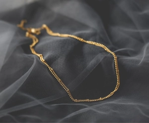 Golden double-layered choker necklace with fine beads and adjustable lobster clasp closure